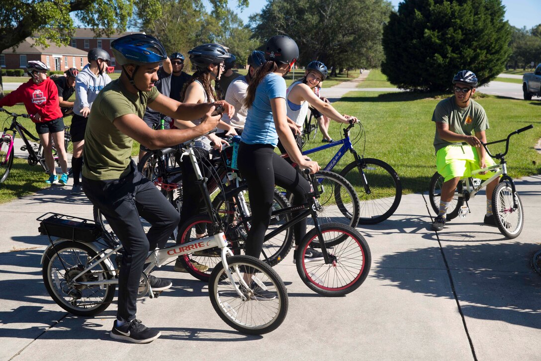 Marines and Sailors socialize prior to a unit bike ride hosted by 2nd Marine Logistics Group at Camp Lejeune, N.C. Oct. 18, 2017. The bike ride afforded participants the opportunity to come together and strengthen unit cohesion and camaraderie. The Participants are with 2nd Marine Logistics Group. (U.S. Marine Corps photo by Pfc. Nicholas Guevara)