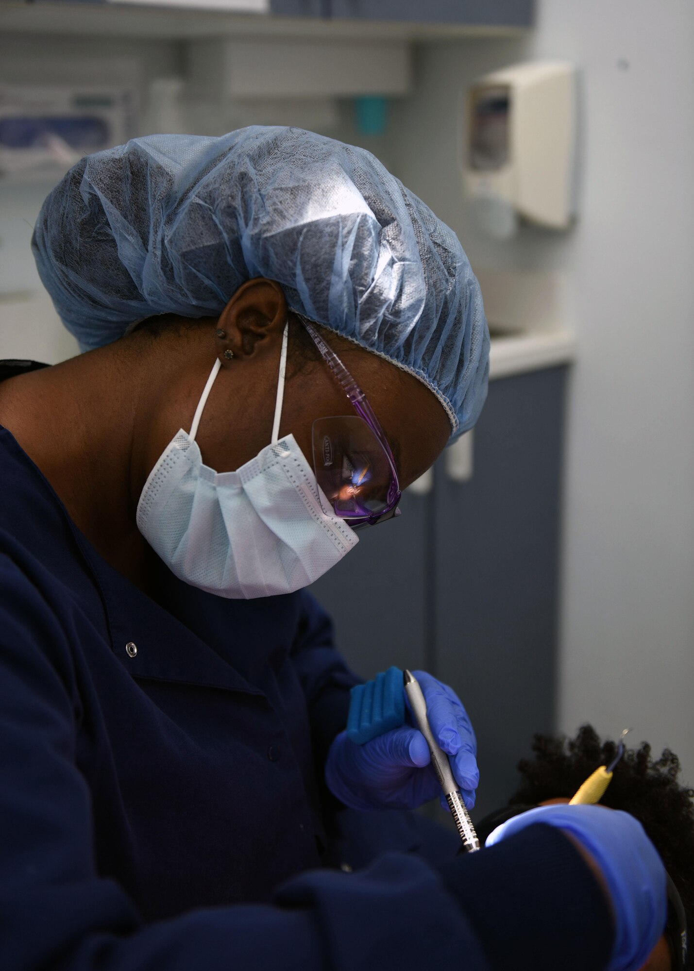 Tech. Sgt. Stephanie Janney, 344th Training Squadron NCOIC of information management, has her teeth cleaned by Aleshiea Johnson, 30th Medical Operations Squadron registered dental assistant, Oct. 18, 2017, Vandenberg Air Force Base, Calif. The dental flight, within the 30th MDOS, is currently celebrating October's National Dental Hygiene Month. The month aims to help raise public awareness on the topic of good oral health and focuses on three main components – brushing teeth daily, flossing, and smart nutrition. (U.S. Air Force photo by Senior Airman Kyla Gifford/Released)