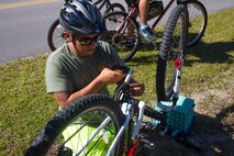 A Marine fixes his bike chain during a unit bike ride at Camp Lejeune, N.C. Oct. 18, 2017. The bike ride afforded participants the opportunity to come together and strengthen unit cohesion and camaraderie. The Participants are with 2nd Marine Logistics Group. (U.S. Marine Corps photo by Pfc. Nicholas Guevara)