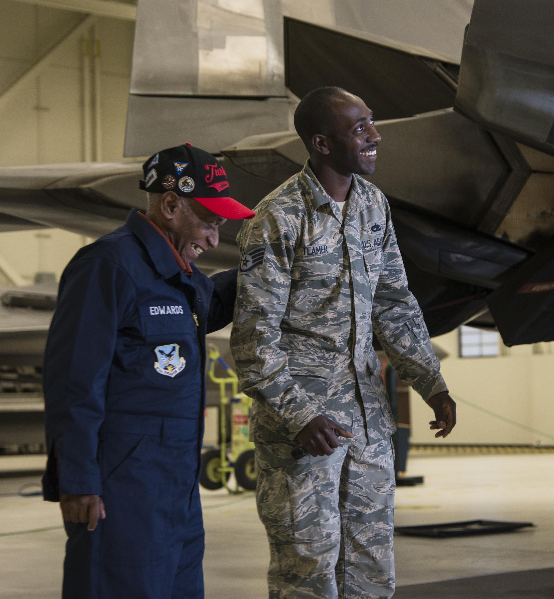 U.S. Army Air Corps Staff Sgt. Leslie Edwards, the last known living Tuskegee Airman of the 477th Bombardment Group, shares a moment with U.S. Air Force Staff Sgt. Stephen Teamer, 477th Aircraft Maintenance Squadron crew chief, at Joint Base Elmendorf-Richardson, Alaska, Oct. 14, 2017. In 2007, the 477th Bombardment Group became the 477th Fighter Group, bringing with it the legacy of Tuskegee Airmen to Alaska. (U.S. Air Force photo by Senior Airman Curt Beach)
