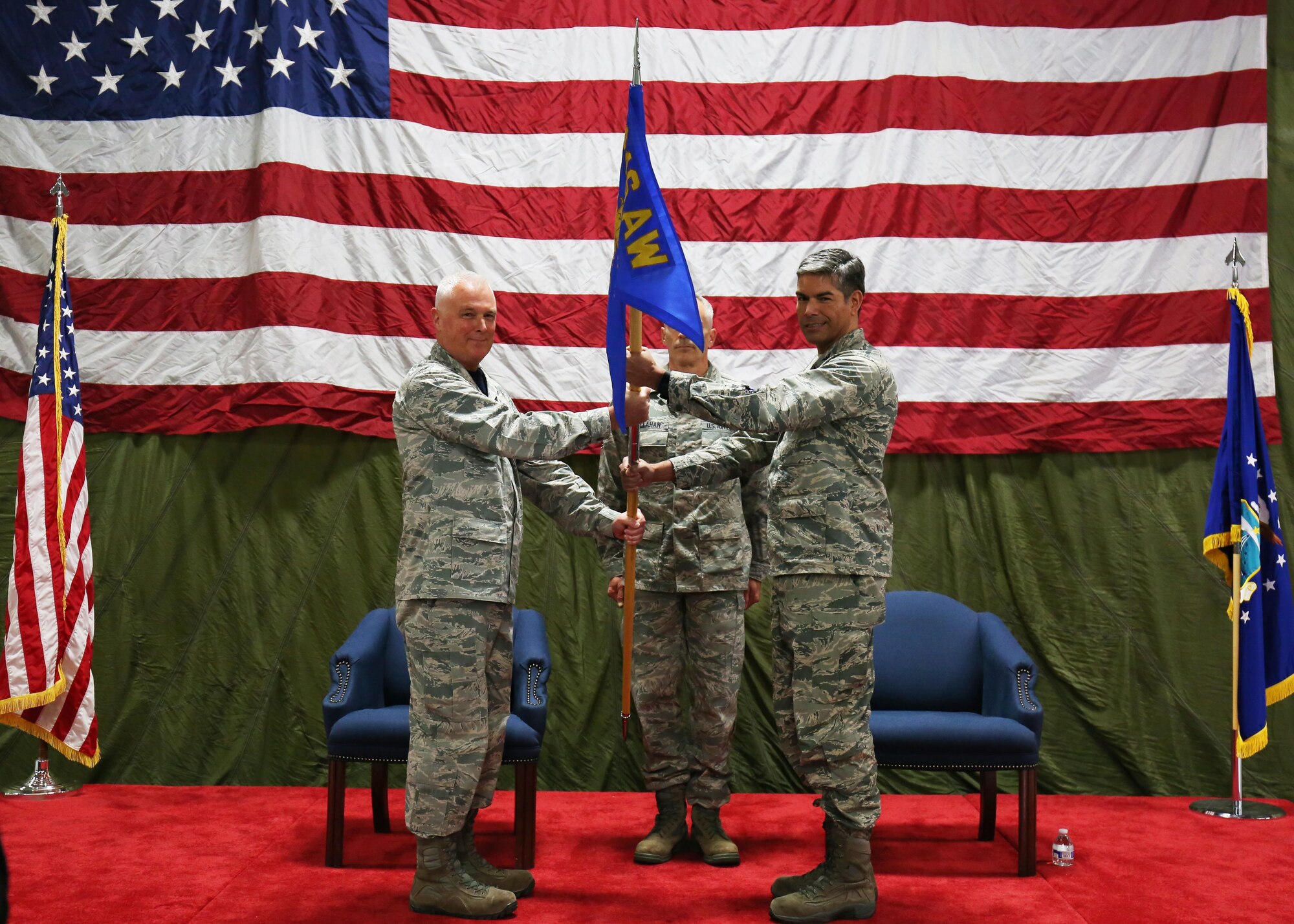 Col. Scott L. McLaughlin, 446th Airlift Wing commander, passes the Mission Support Group guidon to Col. Raymundo Luevanos during an Assumption of Command Ceremony at McChord Field Oct. 14. (U.S. Air Force photo by Tech. Sgt. Bryan Hull)
