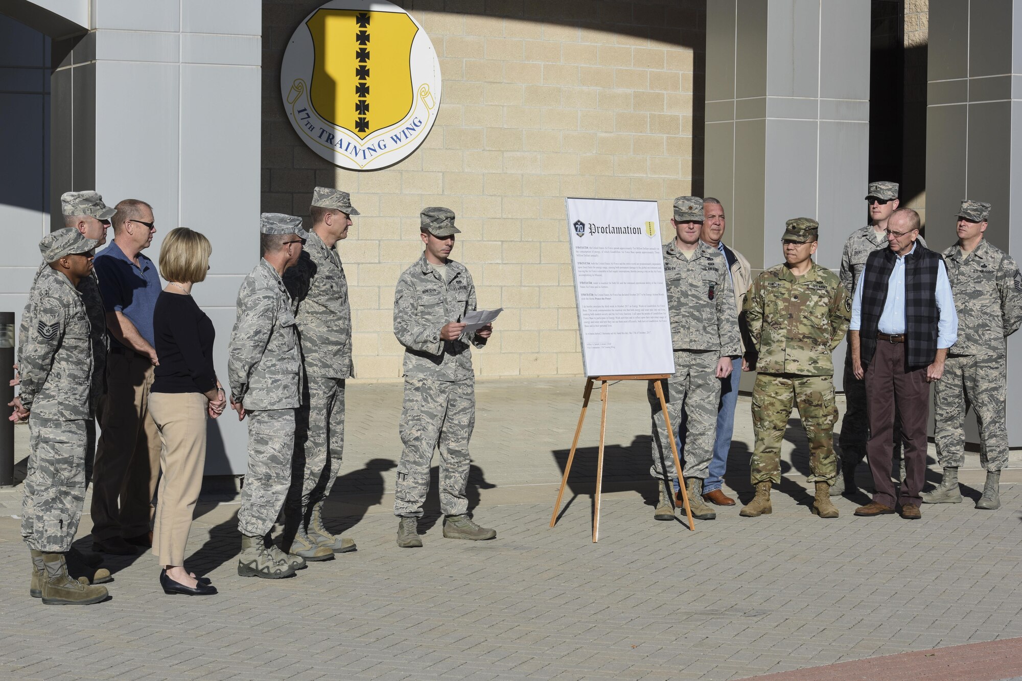 U.S. Air Force Airman Alexander Presley, 17th Civil Engineer Squadron emergency management apprentice, reads the Energy Week proclamation before Col. Jeffrey Sorrell, 17th Training Wing vice commander, signs it in front of the Norma Brown building on Goodfellow Air Force Base, Texas, Oct. 17, 2017. The week of Oct. 17 through 24 was recognized as Energy Week, bringing awareness to the need of energy conservation. (U.S. Air Force photo by Airman 1st Class Zachary Chapman/Released)