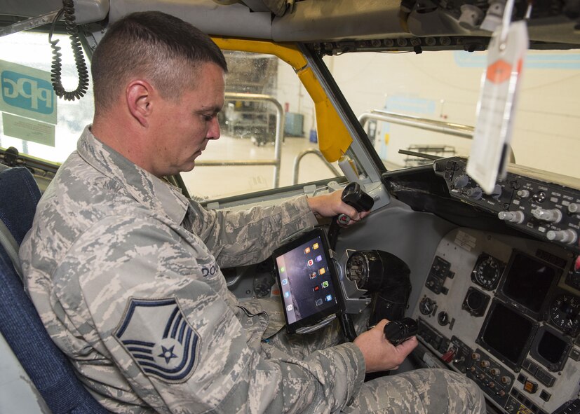 Master Sgt. Gavin Douglas, 92nd Maintenance Group Air Force Repair Enhancement Program manager, tests an iPad mount on the steering column of a KC-135 Stratotanker Oct. 16, 2017, at Fairchild Air Force Base, Washington. The AFREP team has developed specialized iPad mounts
that streamline aircrew’s access to checklists, maps, and line of sight for gauges and flight equipment. (U.S. Air Force photo/Senior Airman Ryan Lackey)