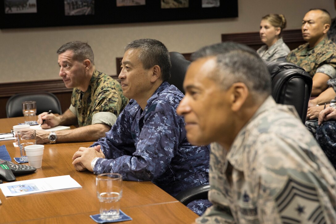 Senior enlisted leaders listen to opening remarks during a symposium at Yokota Air Base, Japan, July 13, 2017
