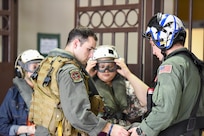 Family members don helmets and goggles.