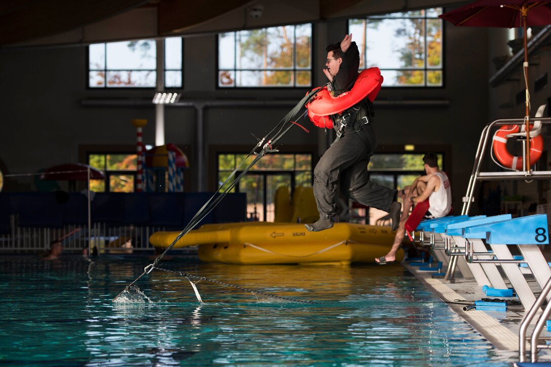Senior Airman Patrick Cassidy, 37th Airlift Squadron loadmaster, is tugged into the water during a survival, evasion, resistance, escape training at Ramstein Air Base, Germany, Oct. 16, 2017.  The training is designed to simulate a member’s parachute being drug by a current after landing in water. (U.S. Air Force photo by Airman 1st Class Devin M. Rumbaugh)