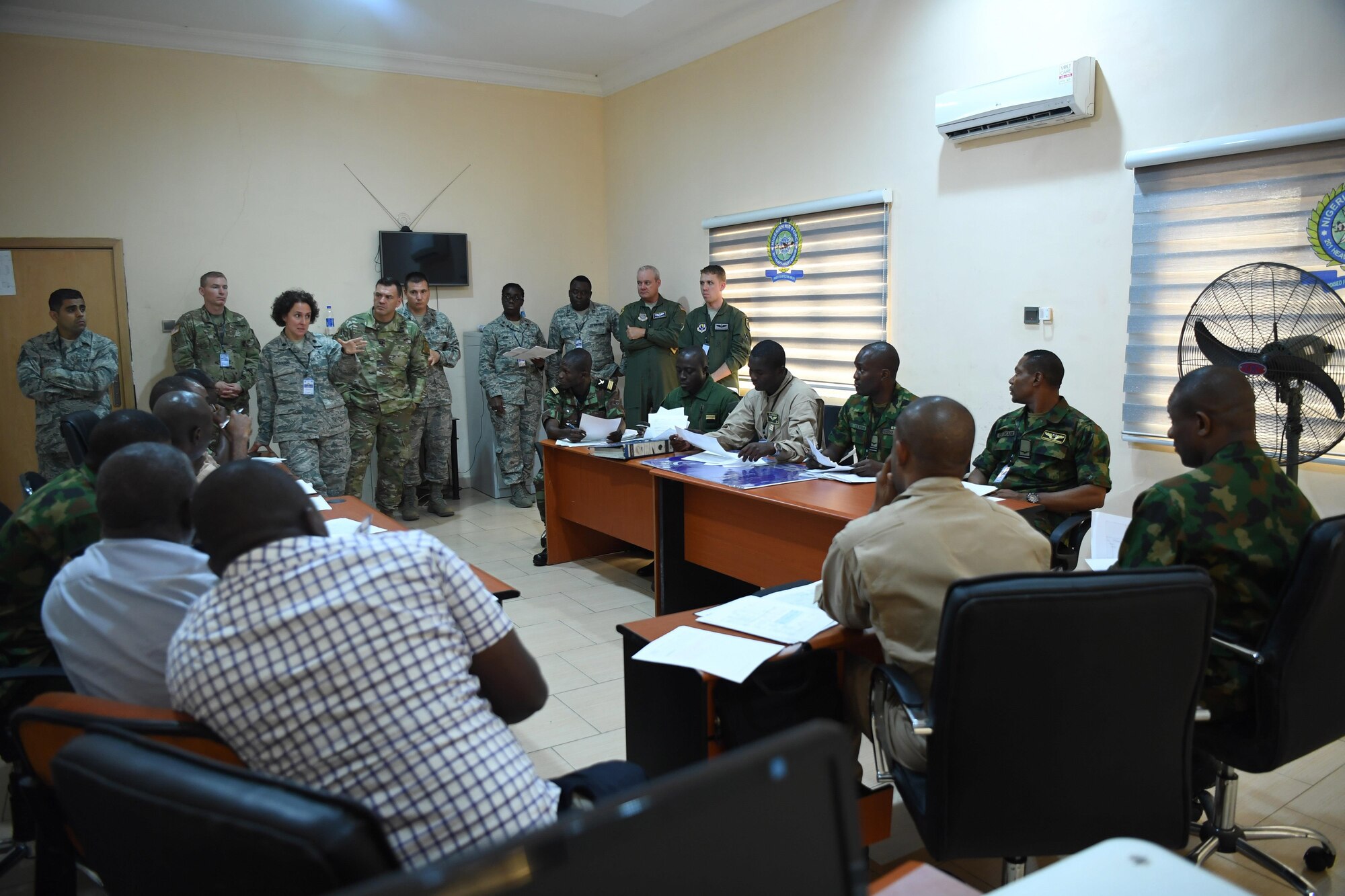 U.S. Air Force Lt. Col. Kimberly Polston, U.S. Air Forces Europe-Air Force Africa Surgeon General internation health specialist team lead, addresses the simulated Multinational Joint Task Force during African Partnership Flight Nigeria, Aug. 16, 2017.