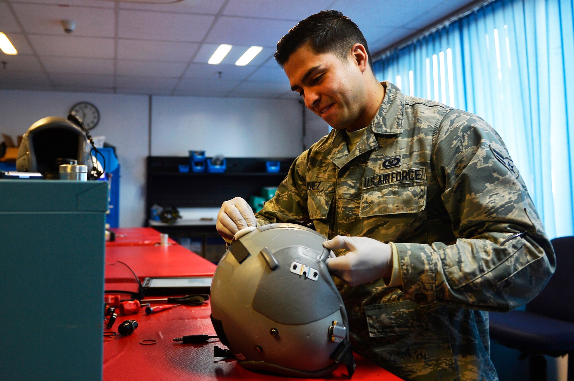 U.S. Air Force Airman 1st Class Manuel Nunez, 86th Operations Support Squadron aircrew flight equipment technician, cleans a helmet on Ramstein Air Base, Germany, Oct. 17, 2017.  Airmen in AFE are responsible for inspecting, maintaining, and keeping accountability of various kinds of equipment used by aircrew. (U.S. Air Force photo by Airman 1st Class Joshua Magbanua)