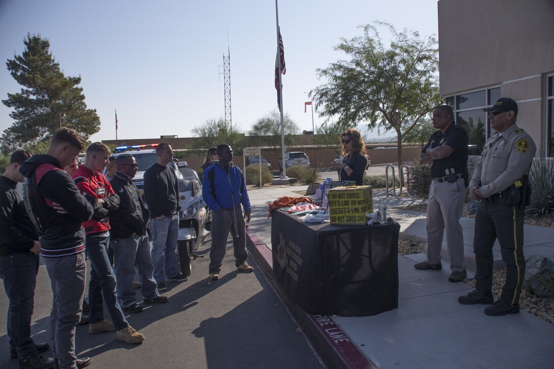 Employees with San Bernardino County Sherriff’s Department brief motorcyclists on the procedures of a domestic violence case during the 4th Annual Roar Against Domestic Violence Motorcycle Ride, Oct. 13, 2017. The ride was hosted to raise awareness for domestic violence amongst Combat Center patrons as well as provide them with resources in the event that they suspect an incident of domestic violence has occurred. (U.S. Marine Corps photo by Cpl. Maliek Fowler)