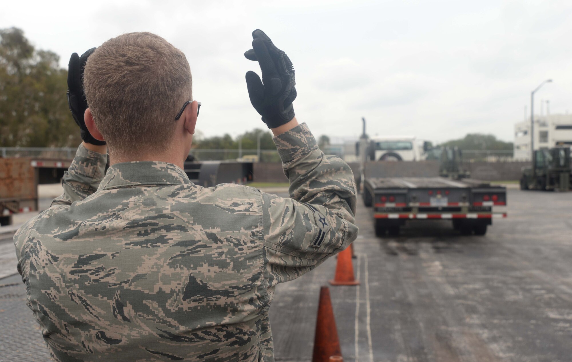 U.S Air Force Airman 1st Class Brandon Gray, a vehicle operator with the 6th Logistics Readiness Squadron, signals a tractor trailer on MacDill Air Force Base, Fla. Oct. 17, 2017.