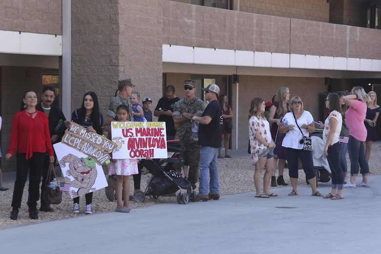 Families and friends await the arrival of Marines and sailors with 1st Battalion, 7th Marine Regiment returning from deployment during the 1/7 homecoming at barracks 1403 and 1404 aboard the Marine Corps Air Ground Combat Center, Twentynine Palms, Calif., Oct. 13, 2017. The Marines had not seen their families for more than six months, and for some Marines this was the first time they held their children.