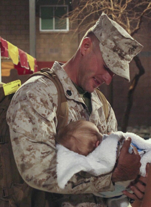 Joshua McGlone, maintenance chief, 1st Battalion, 7th Marine Regiment, meets his son, Jethro McGlone for the first time during 1/7’s homecoming at barracks 1403 and 1404 aboard the Marine Corps Air Ground Combat Center, Twentynine Palms, Calif., Oct. 14, 2017. The Marines had not seen their families for more than six months since being deployed and for some Marines this was the first time they held their children.