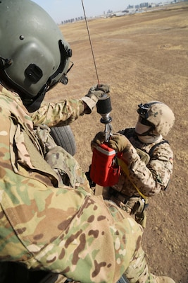 U.S. Army Sgt. Jared Belisle, a crew chief assigned to Company C, 1st General Support Aviation Battalion, 111th Aviation Regiment, Task Force Dragon, guides a German soldier.