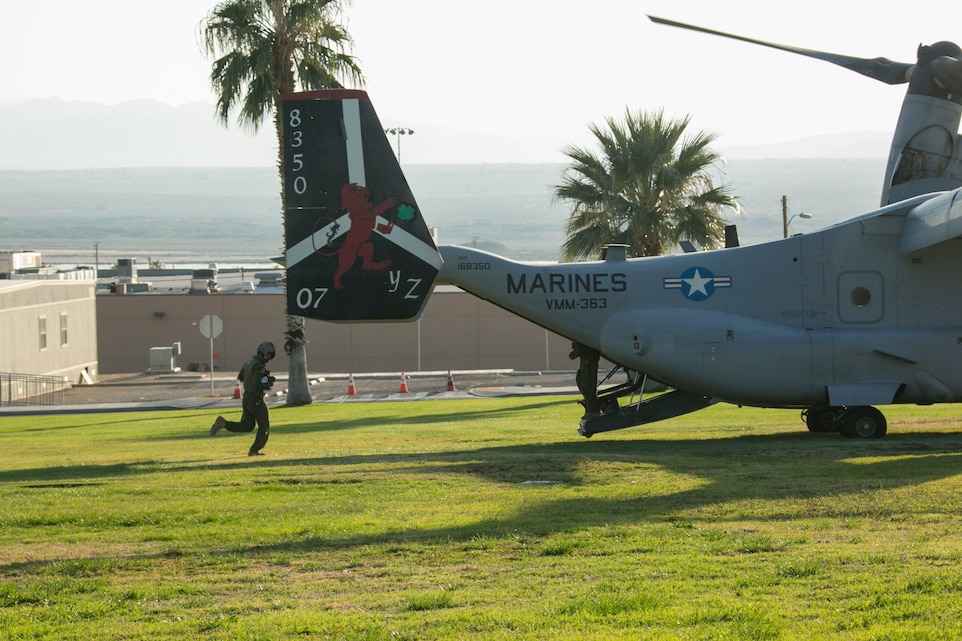 A MV-22 Osprey crew member runs toward an Osprey on Lance Cpl. Torrey L. Gray Field aboard the Marine Corps Air Ground Combat Center, Twentynine Palms, Calif., Oct. 13, 2017. The Osprey crew took part in a non-combatant evacuation operation exercise, which was conducted to prepare Marines for the evacuation of non-essential U.S. citizens and Department of Defense personnel from dangerous situations overseas. (U.S. Marine Corps photo by Lance Cpl. Isaac Cantrell)