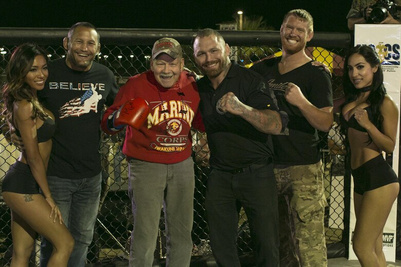 A Marine Corps veteran shows off the signed glove he was awarded during Fight Night at Victory Field, aboard the Marine Corps Air Ground Combat Center, Twentynine Palms, Calif., Oct. 13, 2017. Fight Night is an annual event hosted by Marine Corps Community Services to boost the morale of service members aboard the Combat Center. (U.S. Marine Corps photo by Lance Cpl. Isaac Cantrell)