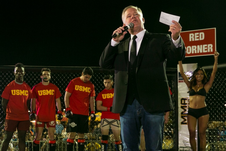 Mike Hart, 23 ABC morning show anchor, presents the fighters of the red corner during Fight Night at Victory Field, aboard the Marine Corps Air Ground Combat Center, Twentynine Palms, Calif., Oct. 13, 2017. Fight Night is an annual event hosted by Marine Corps Community Services to boost the morale of service members aboard the Combat Center. (U.S. Marine Corps photo by Lance Cpl. Isaac Cantrell)