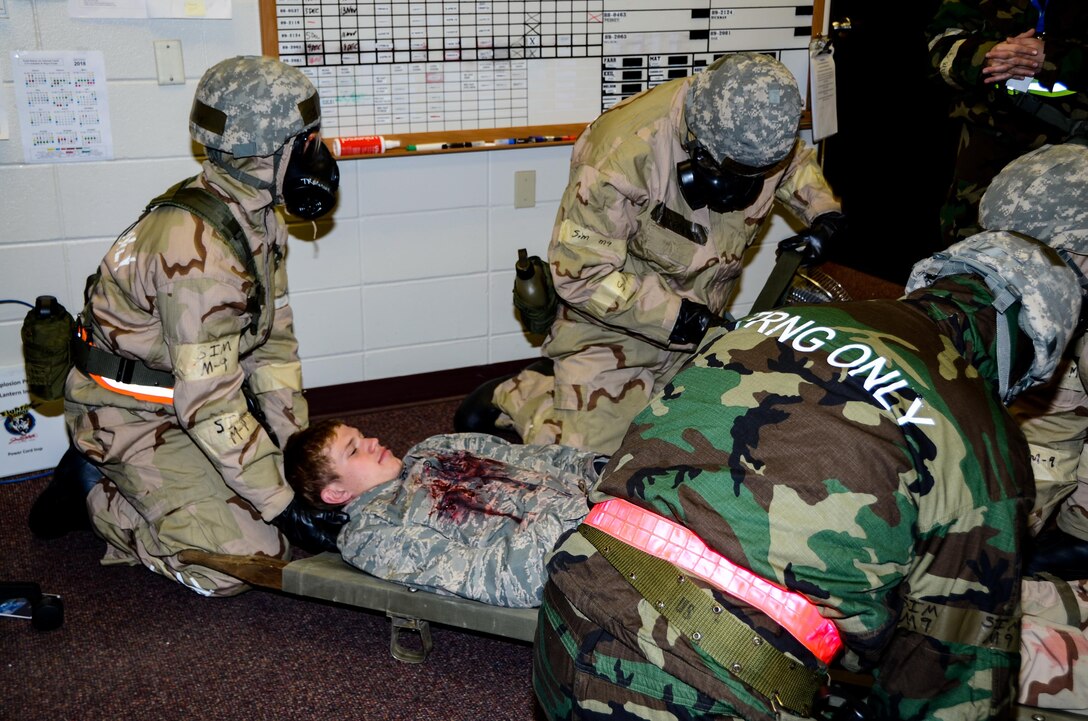 14th Maintenance Squadron Airmen tend to a simulated injured Airman during the Phase 2 of the Attack Response Exercise (ARE) Oct. 14, 2017, Joe Foss Field, S.D.
