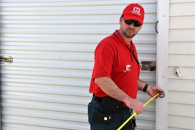 A person measures using a tape measure.