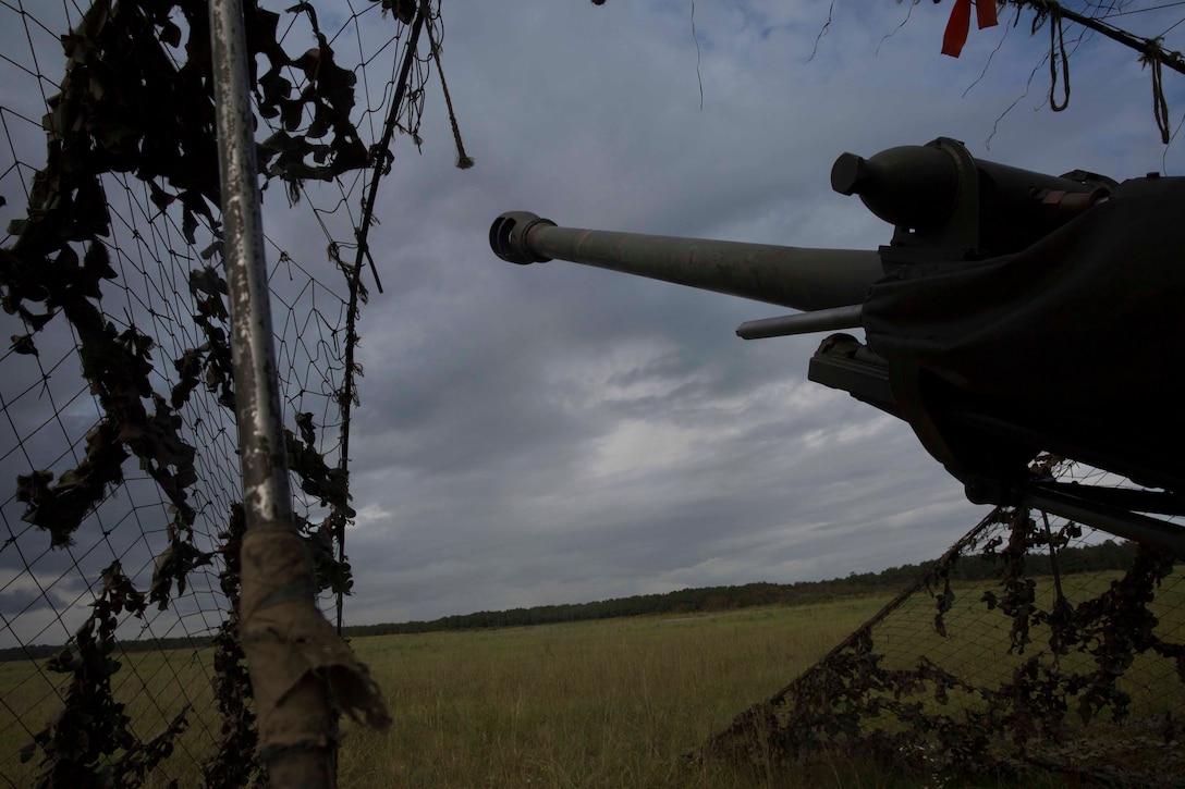 Marine field artillery cannoneers and British commando gunners fire an M119A3 Howitzer during field artillery training at Camp Lejeune, N.C., Oct. 11, 2017. British soldiers exchanged knowledge and skills with U.S. Marines to refine their artillery operation capabilities in preparation for joint exercise Bold Alligator, a large-scale, multinational Naval amphibious exercise to execute complex shaping, amphibious, and sea basing operations to improve U.S. and coalition ship-to-shore capabilities. The Marines are with 2nd Battalion, 10th Marine Regiment and the British soldiers are with 29 Commando Regiment, Royal Artillery. (U.S. Marine Corps photo by Pfc. Nicholas Guevara)