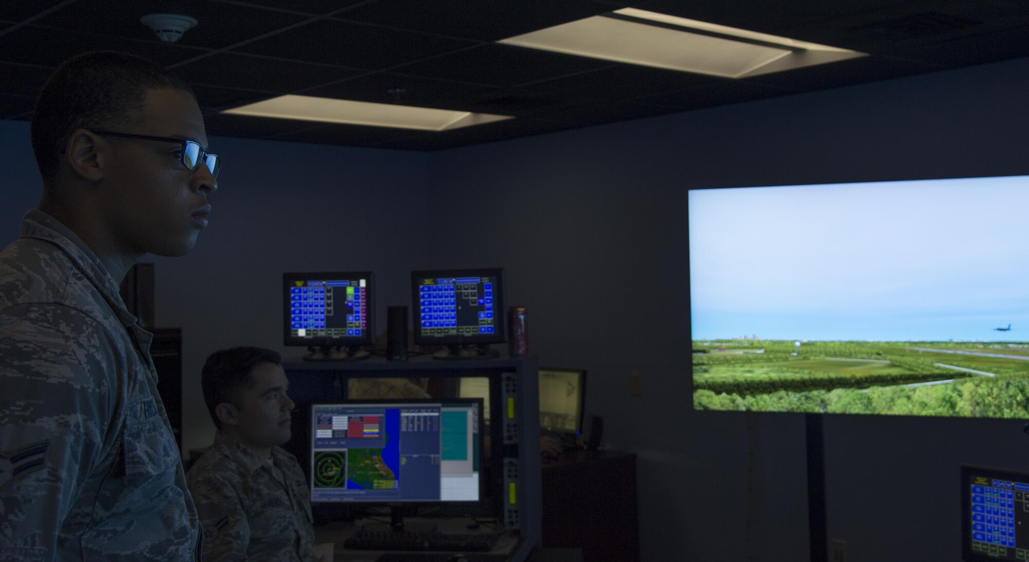 U.S. Air Force Airman 1st Class Keith Hickson Jr., left, a cable and antenna maintenance technician assigned to the 6th Communications Squadron, observes a simulation in the air traffic control tower during a Shadow Program at MacDill Air Force Base, Fla. Oct. 18, 2017. The MacDill Shadow Program was created to help Airmen gain a greater perspective into another career field and how each Airman and unit factors into the Air Force mission. (U.S. Air Force photo by Senior Airman Mariette Adams)