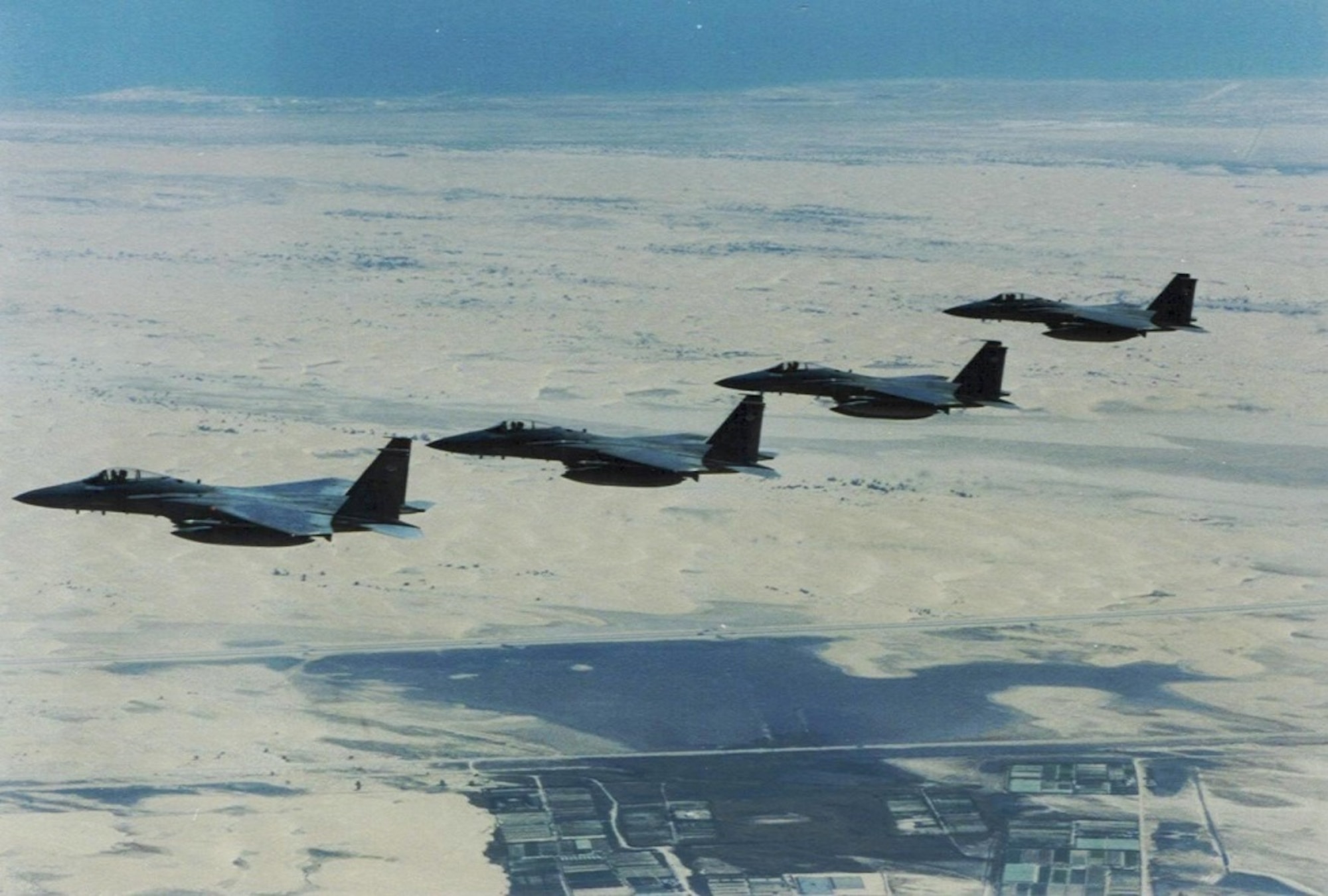 In this historic photo, a four-ship of F-15 Eagles, deployed from Eglin, fly over the Persian Gulf. Throughout the 90s, then-named 33rd Tactical Fighter Wing flew combat air patrol and high value airborne asset protection missions as part of Operations DESERT STORM and SOUTHERN WATCH. Known for the most combat kills, the wing "Nomads" ended the operational missions with 16 aerial victories. Today, the wing continues its air dominance by training pilots and maintainers for the military's future generation as DoD's Integrated Training Center for the F-35. (Courtesy photo)