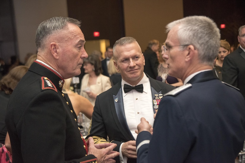 Marine Corps Gen. Joe Dunford, chairman of the Joint Chiefs of Staff; Army Command Sgt. Maj. John W. Troxell, senior enlisted advisor to the chairman of the Joint Chiefs of Staff; and Air Force Gen. Paul J. Selva, vice chairman of the Joint Chiefs of Staff; speak before the start of the 2017 USO Gala in Washington.