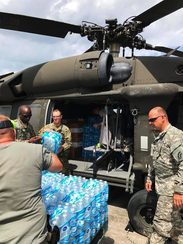 Food and supplies are loaded onto a UH-60 Black Hawk helicopter for delivery.