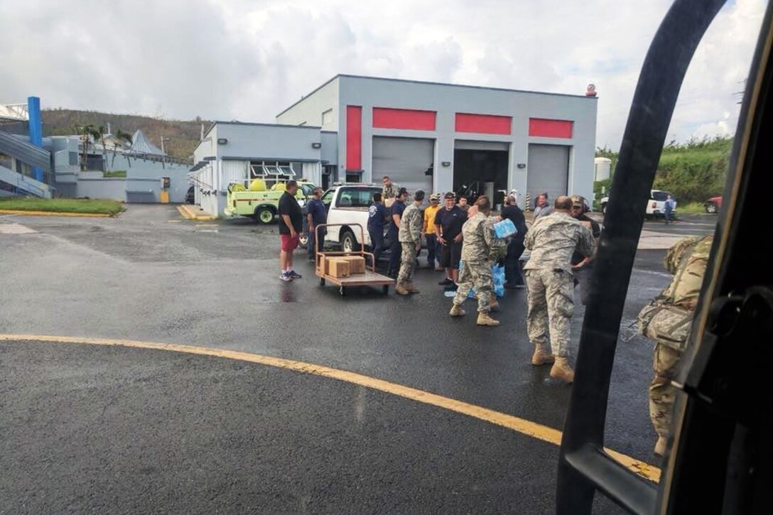 Soldiers assigned to the New York Army National Guard's 3rd Battalion, 142nd Aviation Regiment deliver food and water to locals during relief missions in Viques, Puerto Rico.