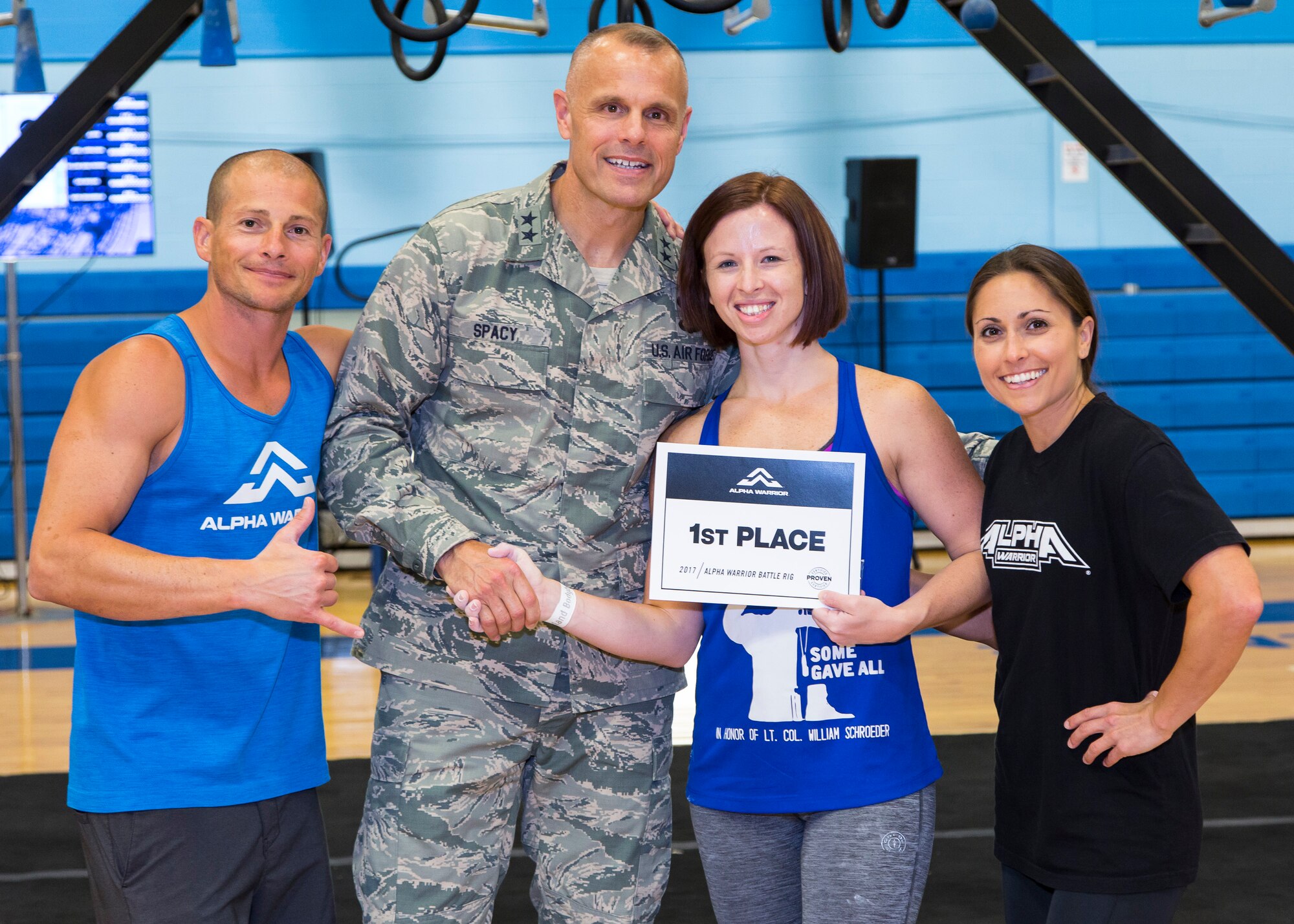 Maj. Gen. Brad Spacy (middle), AFIMSC commander, awarding a certificate to an Alpha Warrior participant, will be on hand for the Air Force Alpha Warrior Final Battle Nov. 11 and commemorate Veterans Day with opening remarks.