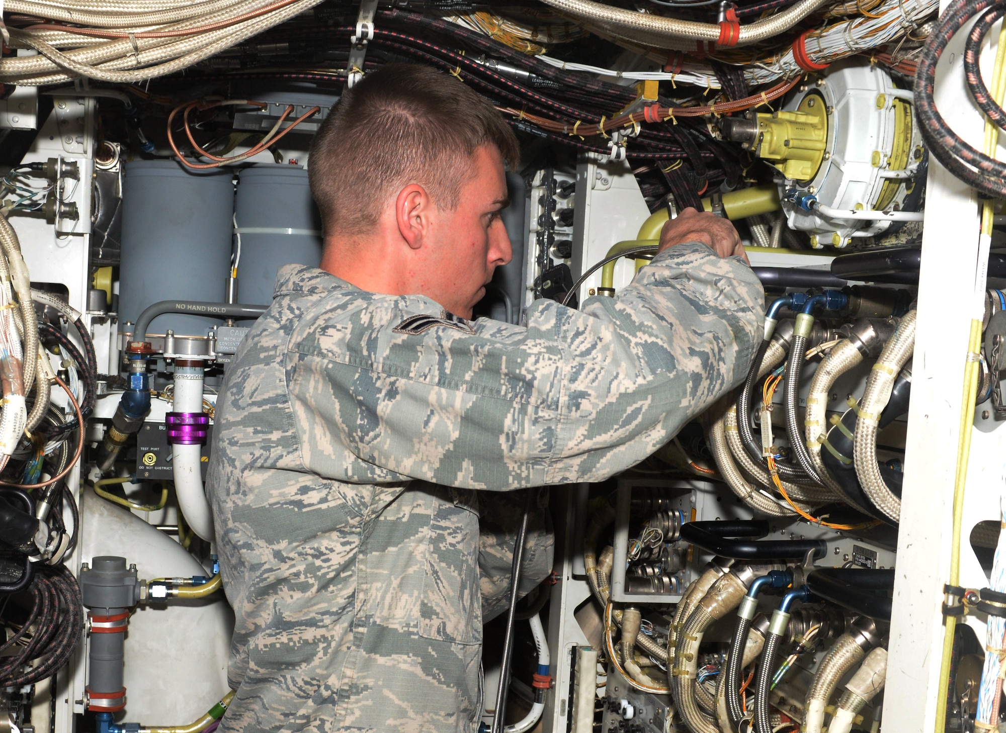 Airman 1st Class Justin Bussell, an aerospace propulsion technician assigned to the 28th Aircraft Maintenance Squadron, repairs cables inside a B-1 Bomber at Ellsworth Air Force Base, S.D., Oct. 17, 2017. Bussell and the other maintainers had to ensure the aircraft leaving for Green Flag 18-1 were at their peak performance. (U.S. Air Force photo by Airman 1st Class Thomas Karol)