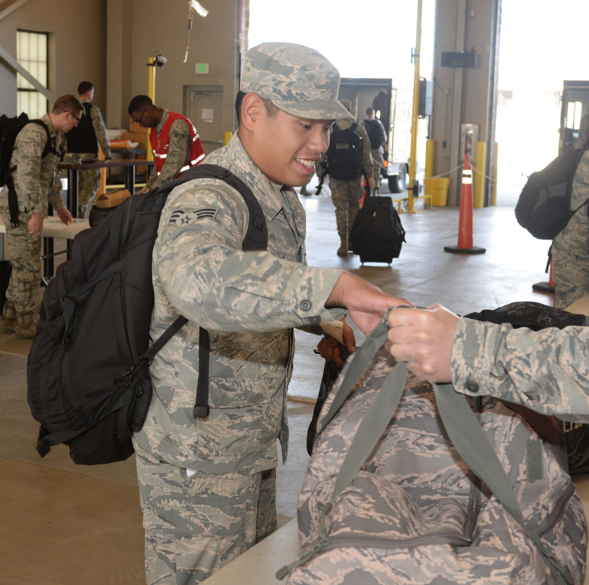 Senior Airman Peter J. Mandadero, a fuels facility operator assigned to the 28th Logistics Readiness Squadron, completes his bag check in the deployment center at Ellsworth Air Force Base, S.D., Oct. 16, 2017. More than 200 Airmen deployed to Nellis Air Force Base, Nev. to take part in Green Flag 18-1, a joint training exercise focused on air-to-ground and close-air support missions. (U.S. Air Force photo by Airman 1st Class Thomas Karol)