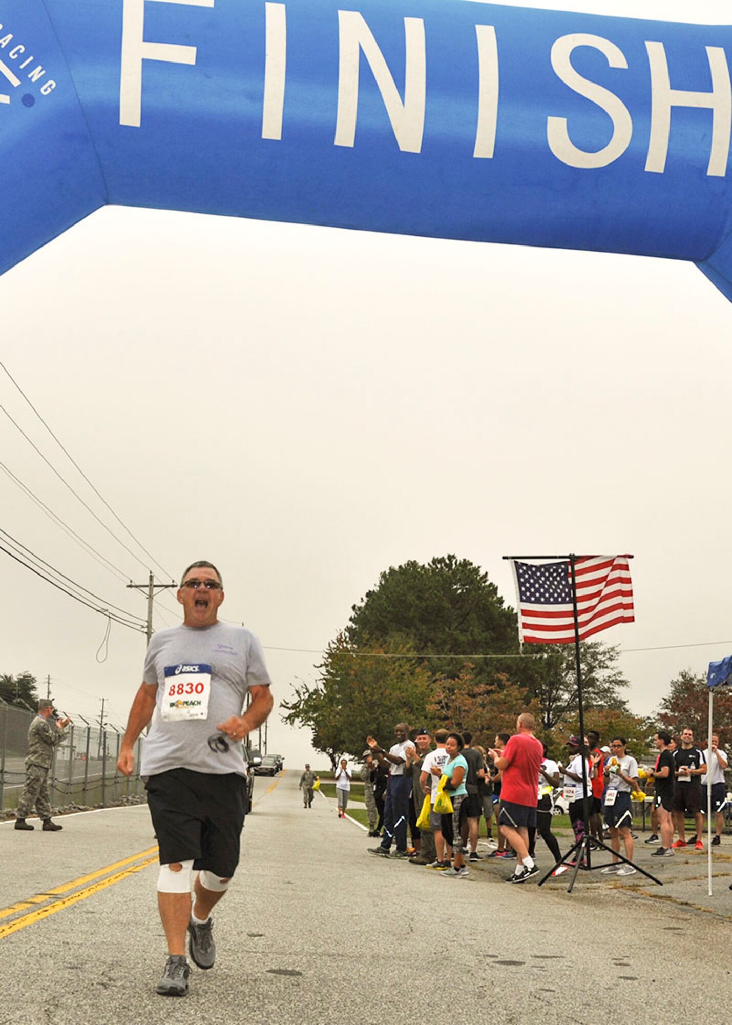Master Sgt. (Ret.) Samuel Farmer of the 94th Civil Engineering Squadron, crosses the finish line of the 2017 Falcon 5K Run Oct. 15, 2017. After recently rocovering from open-heart surgery, Farmer wanted to complete the run, and support Airmen in need. (U.S. Air Force photo/Master Sgt. James Branch)