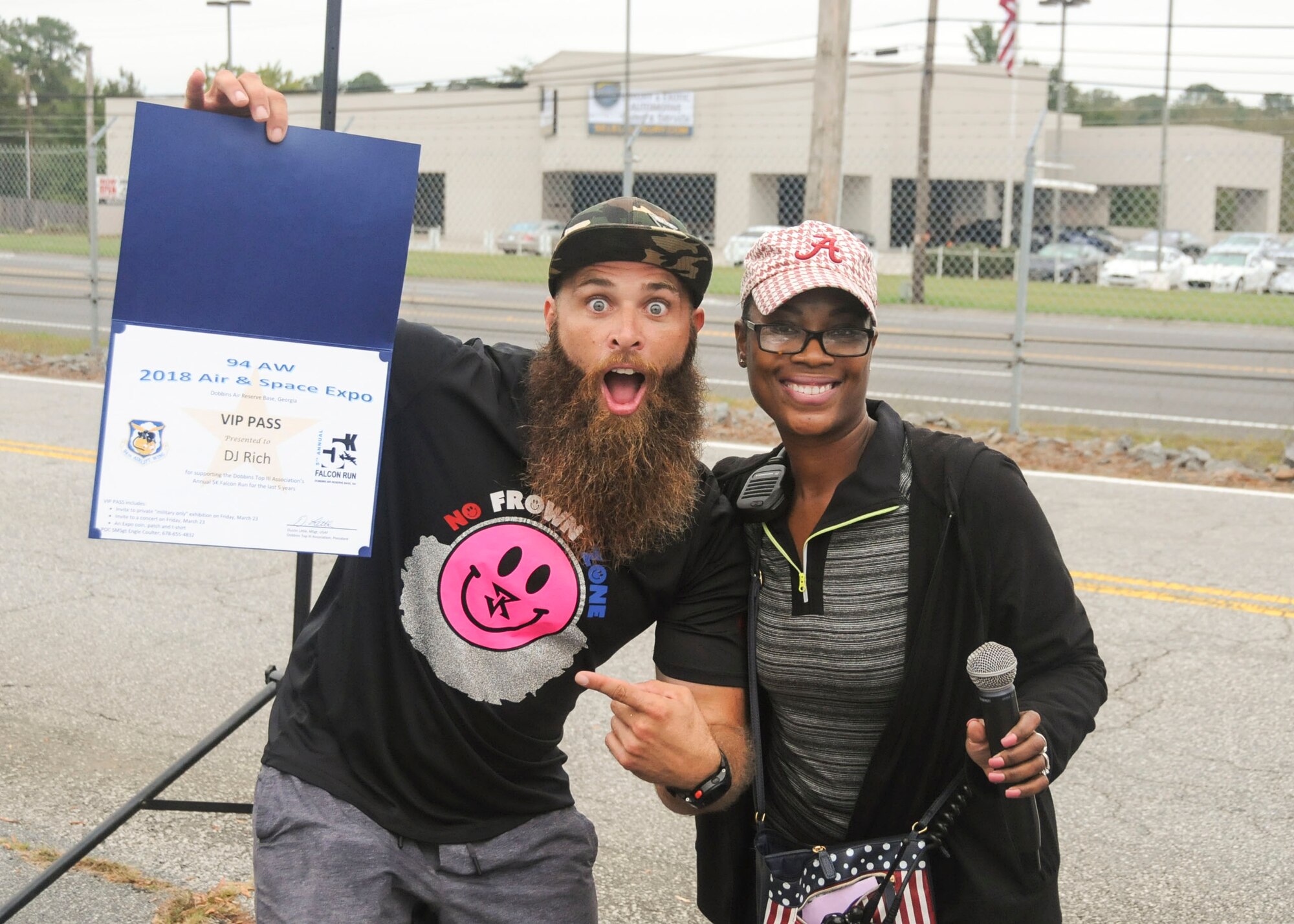 Jarian Rich poses for a photo with Senior Master Sgt. Engle Coulter, 94th Security Forces Squadron operations superintendent, at this year's Falcon 5K at Dobbins Air Reserve Base, Ga. Oct. 15, 2017. Rich was awarded a certificate for his commitment and loyal service of providing music to the Falcon 5K events. (U.S. Air Force photo/Senior Airman Justin Clayvon)