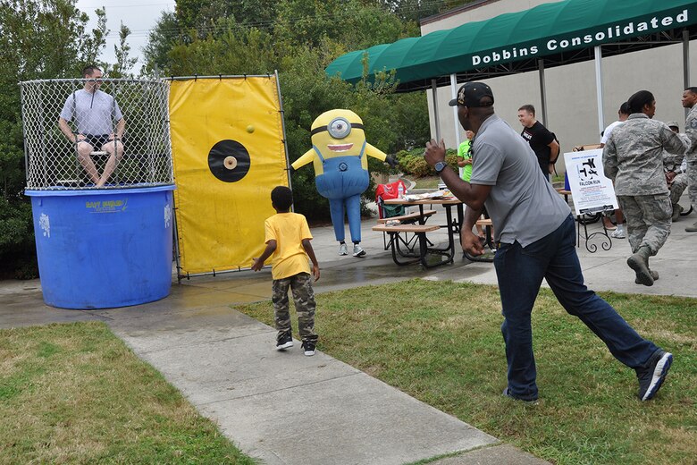 A man throws a ball at a dunk tank target at this year's Family Day Oct. 14, 2017 at Dobbins Air Reserve Base, Ga. Family Day is held here annually as a way of bringing families on base to see what their Reserve Citizen Airmen do on drill weekends. (U.S. Air Force photo/Master Sgt. James Branch)
