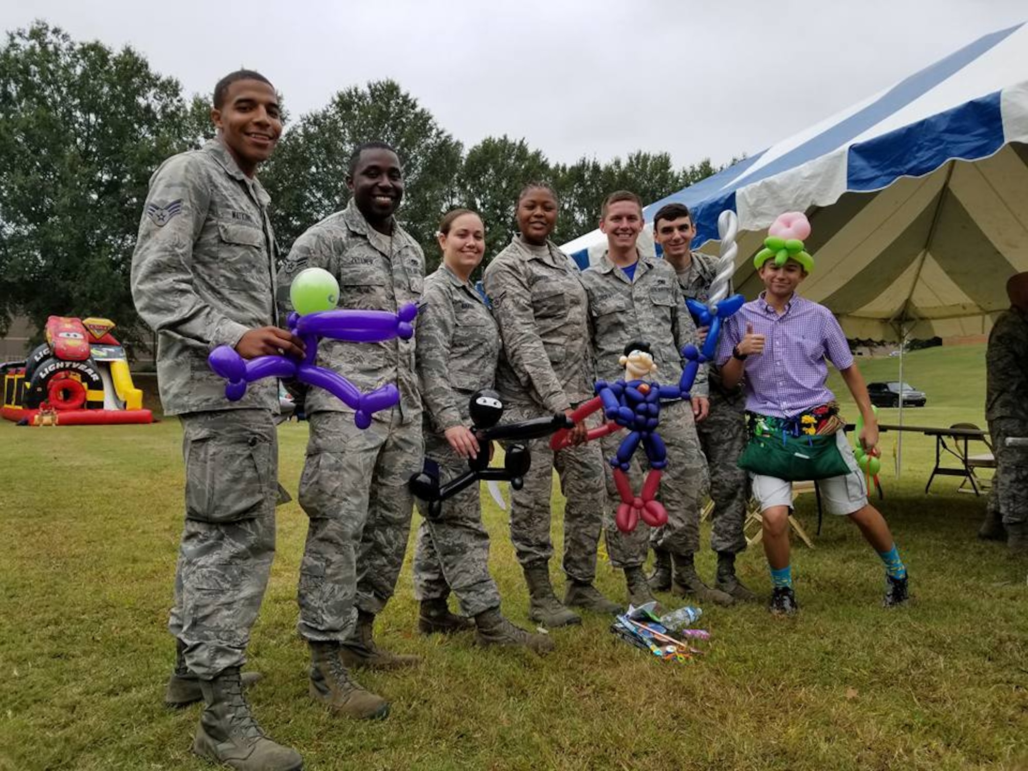 Reserve Citizen Airmen pose for a photo with their balloon animals at this year's Family Day Oct. 14, 2017 at Dobbins Air Reserve Base, Ga. Family Day is held here annually as a way of bringing families on base to see what their Reserve Citizen Airmen do on drill weekends. (U.S. Air Force photo/Senior Airman Lauren Douglas)