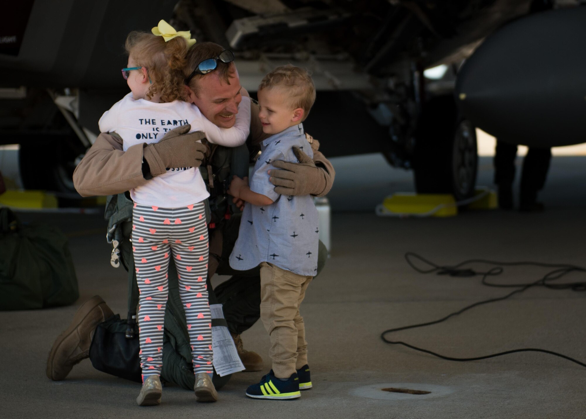 U.S. Air Force Lt. Col. Christian Bergtholdt, 27th Fighter Squadron director of operations, embraces his children upon returning to Joint Base Langley-Eustis, Va., Oct. 19, 2017.