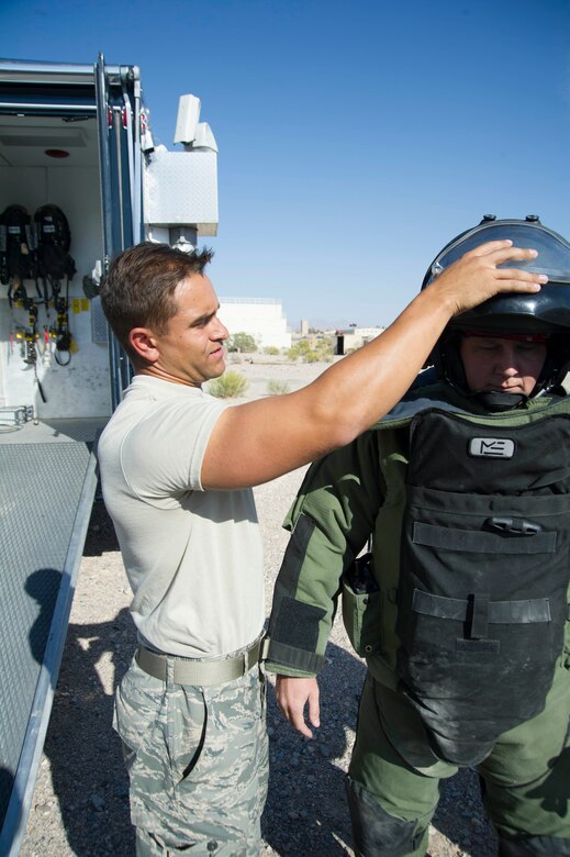 Senior Airman Jon Brauch adjusts a blast suit during an EOD exercise.