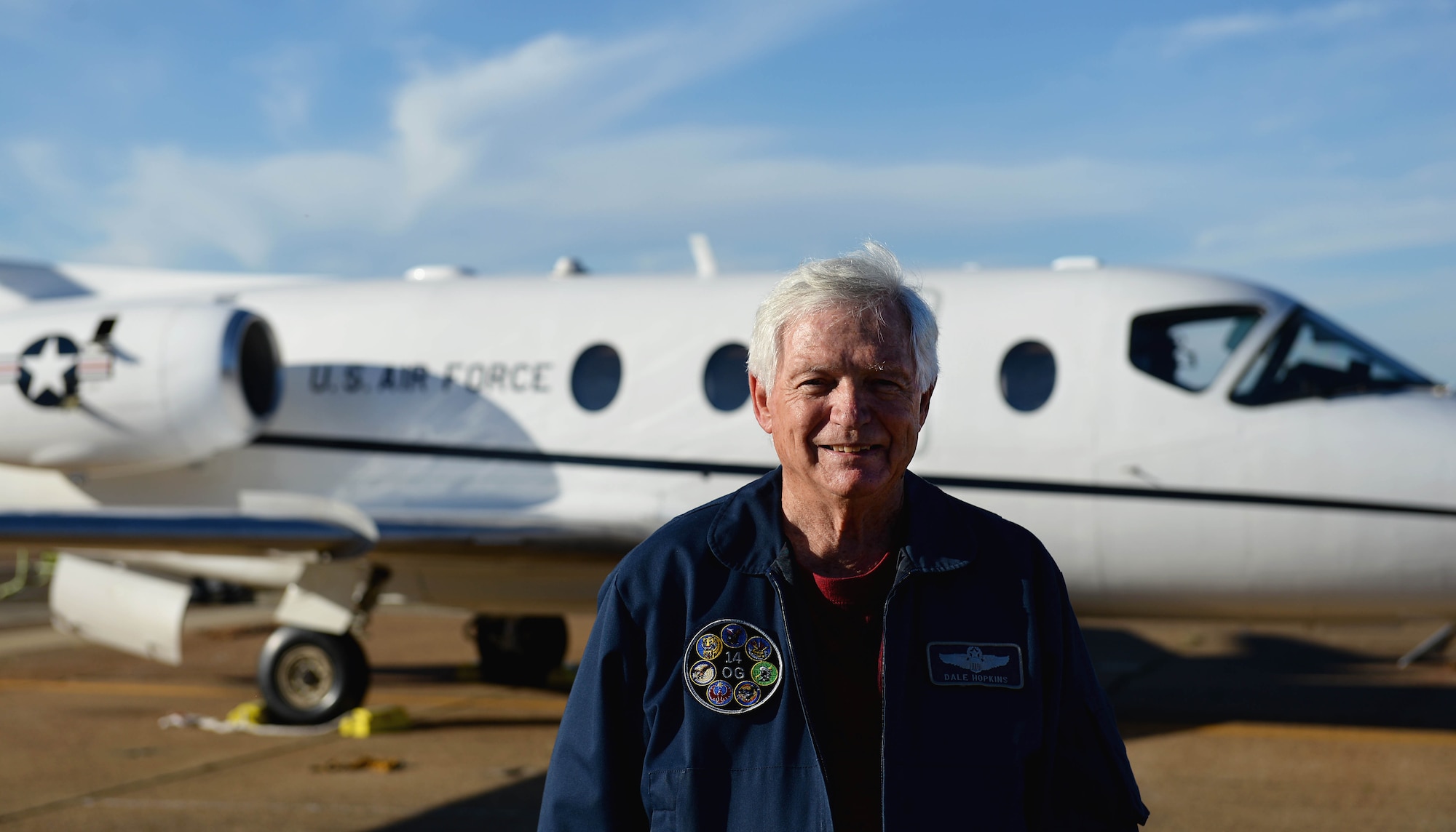 Dale Hopkins, T-1A Jayhawk simulation instructor pilot, stands in front of a T-1A Oct. 17, 2017, on Columbus Air Force Base, Mississippi. Since he retired as a colonel in 1989, he has continued his service to the Air Force as a sim instructor, his passion for aviation helping him teach the newest Air Force pilots. (U.S. Air Force photo by Airman 1st Class Keith Holcomb)