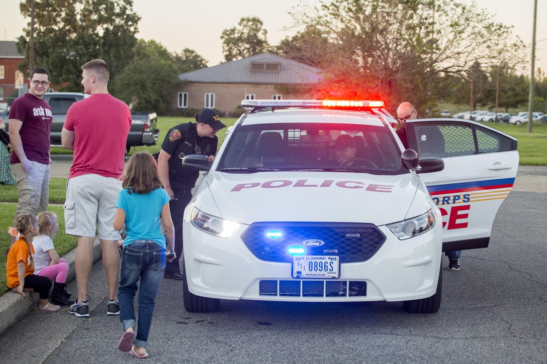 Police officers with New Orleans Police Department let families sit in a patrol car to see how it operates, at The Village at Federal City in New Orleans, Oct. 17, 2017. NOPD officers held “A Night Out Against Crime” to not only bring together Federal City and other community members, but to also raise awareness about the presence of the police force in the New Orleans area. ANOAC is a yearly, nationwide community-building campaign that promotes police-to-community partnerships and neighborhood camaraderie to make neighborhoods a safer and better place to live.