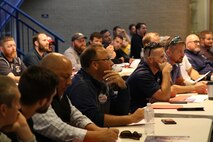 Wrestling coaches listen to Colonel David Fallon, the 9th Marine Corps District commanding officer, talk about Marine Corps leadership at the National Wrestling Coaches Association’s Leadership Academy at Shawnee High School, Oct. 19.  Colonel David Fallon, the 9th Marine Corps District commanding officer, spoke to the coaches about how the Marine Corps will enhance their wrestling programs. (Official U.S. Marine photo by Sgt. Marcela Diazdeleon)