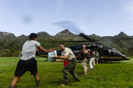 The U.S. Department of Homeland Security delivers food and water to isolated Puerto Rico residents after their bridge was destroyed by Hurricane Maria in the mountains around Utuado, Puerto Rico, Oct. 12, 2017. The Federal Emergency Management Agency and its federal partners continue 24-hour operations to conduct missions in support of those affected by Hurricane Maria.