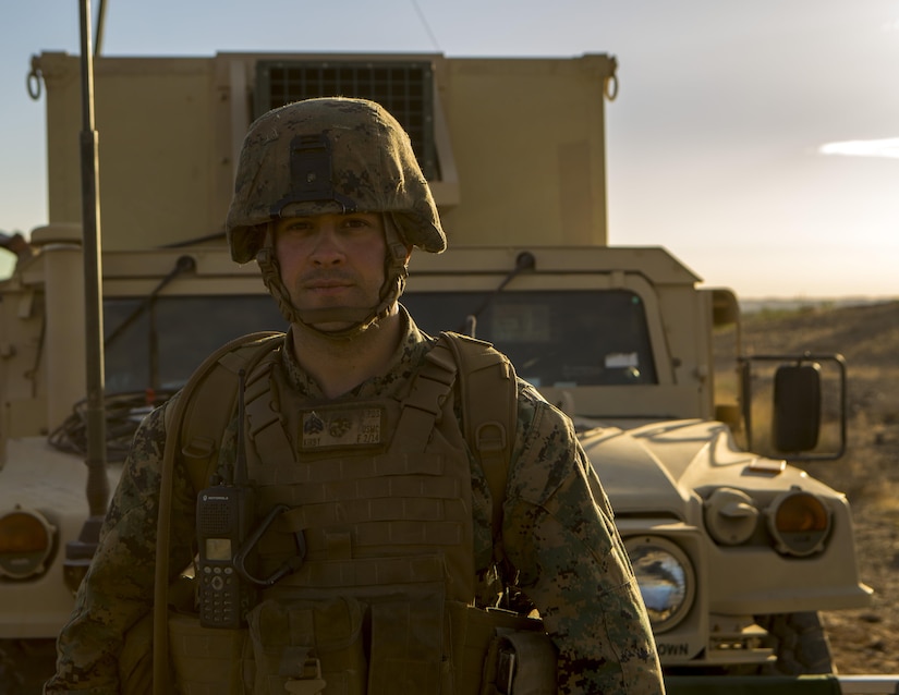 Sgt. Michael Kirby, a radio chief with 3rd Platoon, Rocket Battery F, 2nd Battalion, 14th Marine Regiment, 4th Marine Division, Marine Forces Reserve, poses for a photo in front of a Humvee during Weapons and Tactics Instructor course 1-18 at Chocolate Mountain Aerial Gunnery Range, Calif., Oct. 12, 2017.