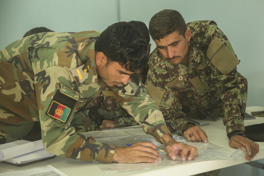 Afghan National Army soldiers with Artillery Brigade, 215th Corps plot grids during a map reading class as part of an artillery course at Camp Shorabak, Afghanistan, Oct. 21, 2017. More than 20 soldiers with the brigade, including forward observers, artillery crewmen and a fire direction control team are undergoing the eight-week course, which teaches proper employment of the 122mm howitzer D-30. (U.S. Marine Corps photo by Sgt. Lucas Hopkins)