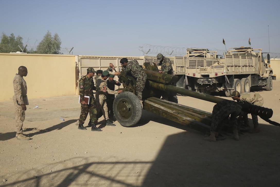 A U.S. Marine advisor observes as Afghan National Army soldiers with Artillery Brigade, 215th Corps execute a gun drill on a 122mm howitzer D-30 during an artillery course at Camp Shorabak, Afghanistan, Oct. 21, 2017. The eight-week training program incorporates forward observers, artillery crewmen and a fire direction control team, and is designed to enhance their employment of artillery assets and gain hands-on skills with the D-30 weapon system. (U.S. Marine Corps photo by Sgt. Lucas Hopkins)