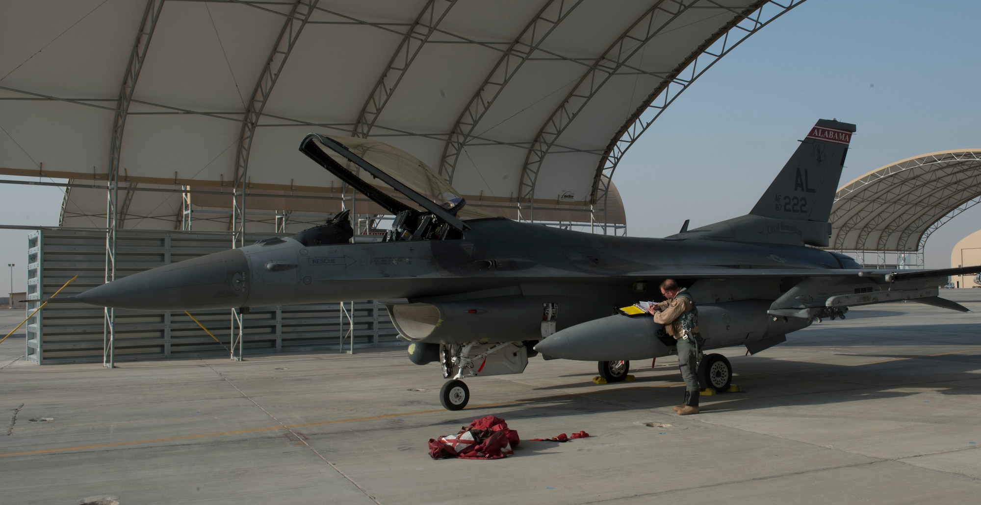 An F-16 Fighting Falcon pilot from the 100th Fighter Squadron fills out post-flight paperwork at the 407th Air Expeditionary Group in Southwest Asia, Oct. 16, 2017. In an air combat role, the F-16's maneuverability and combat radius exceed that of all potential threat fighter aircraft. It can locate targets in all weather conditions and detect low flying aircraft in radar ground clutter. (U.S. Air Force photo by Staff Sgt. Sean Martin/Released)