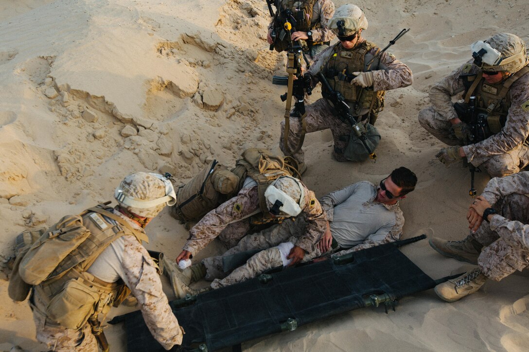 U.S. service members with 2nd Battalion, 7th Marine Regiment triage the simulated casualty and apply a splint before evacuating him to safety during a quick reaction force exercise in the Middle East, Oct. 10, 2017. They are part of a quick reaction force that is capable of responding to developing situations on short notice. Marines with 2/7 were tasked to conduct a QRF to quickly recover simulated casualties and take them back to safety. This was the first exercise 2/7 has conducted after replacing 1st Battalion, 7th Marine Regiment in the U.S. Central Command area of operations.