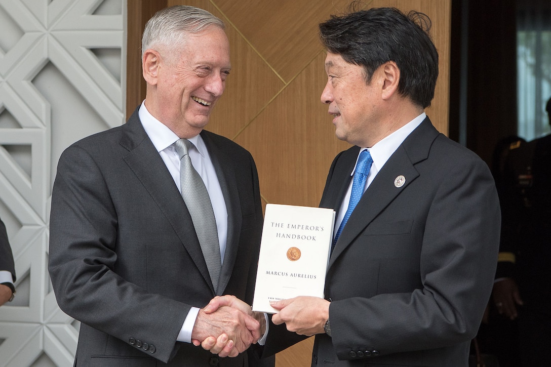 U.S. and Japanese defense leaders shake hands in the Philippines.