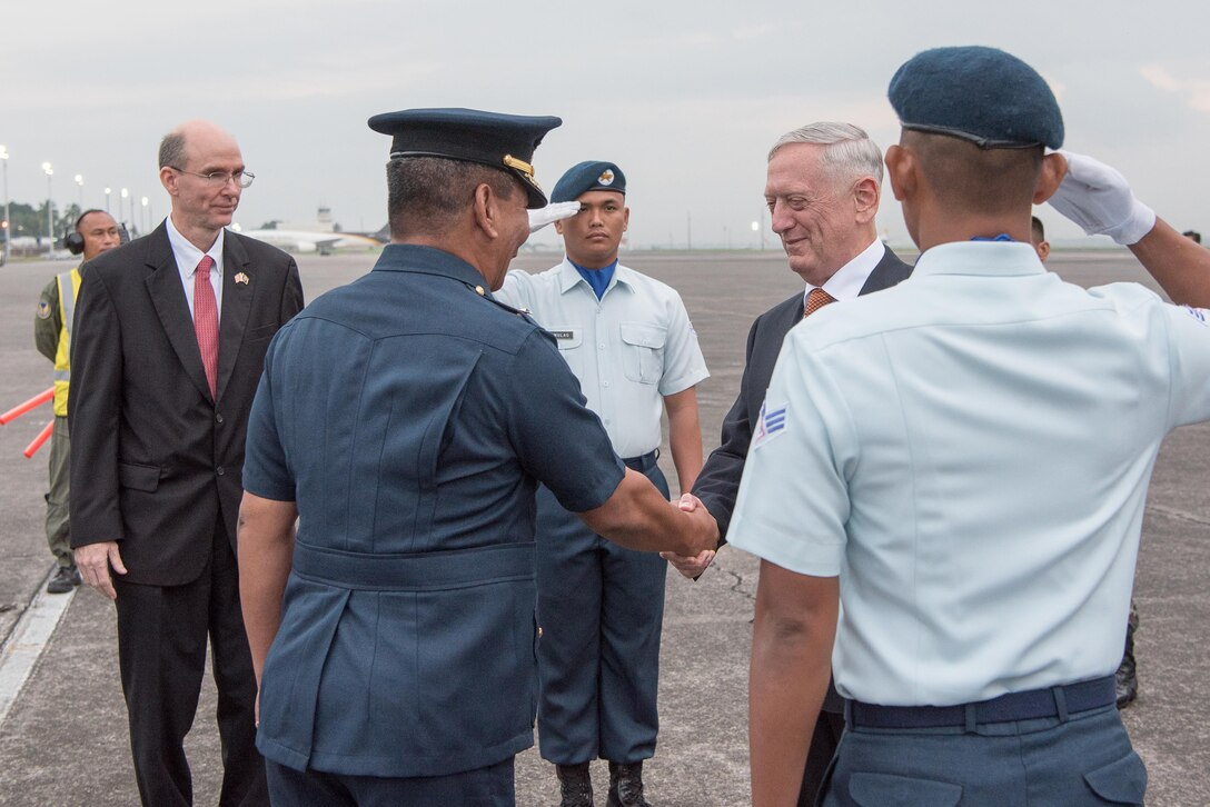 Defense Secretary Jim Mattis is greeted by Philippine defense officials after arriving in Clark, Philippines.