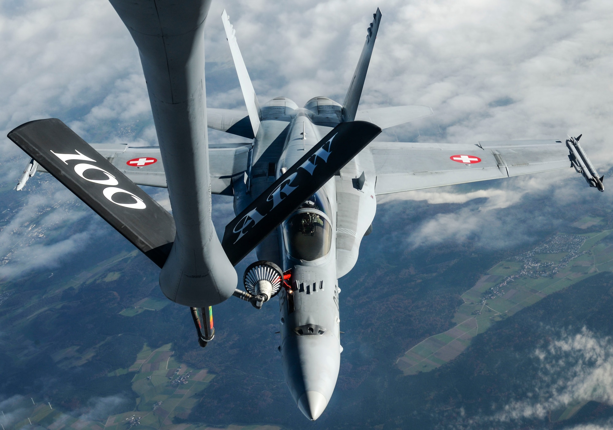 A U.S. Air Force KC-135 Stratotanker, assigned to the 100th Air Refueling Wing RAF Mildenhall, England, refuels a Swiss air force F-18 Hornet over Germany Oct 20, 2017. The 100th ARW theatre of operations covers Europe and Africa, supporting NATO and other nation missions.  (U.S. Air Force photo by Senior Airman Justine Rho)