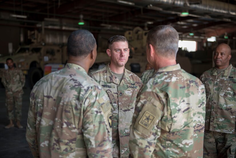 Three soldiers standing together in a group.